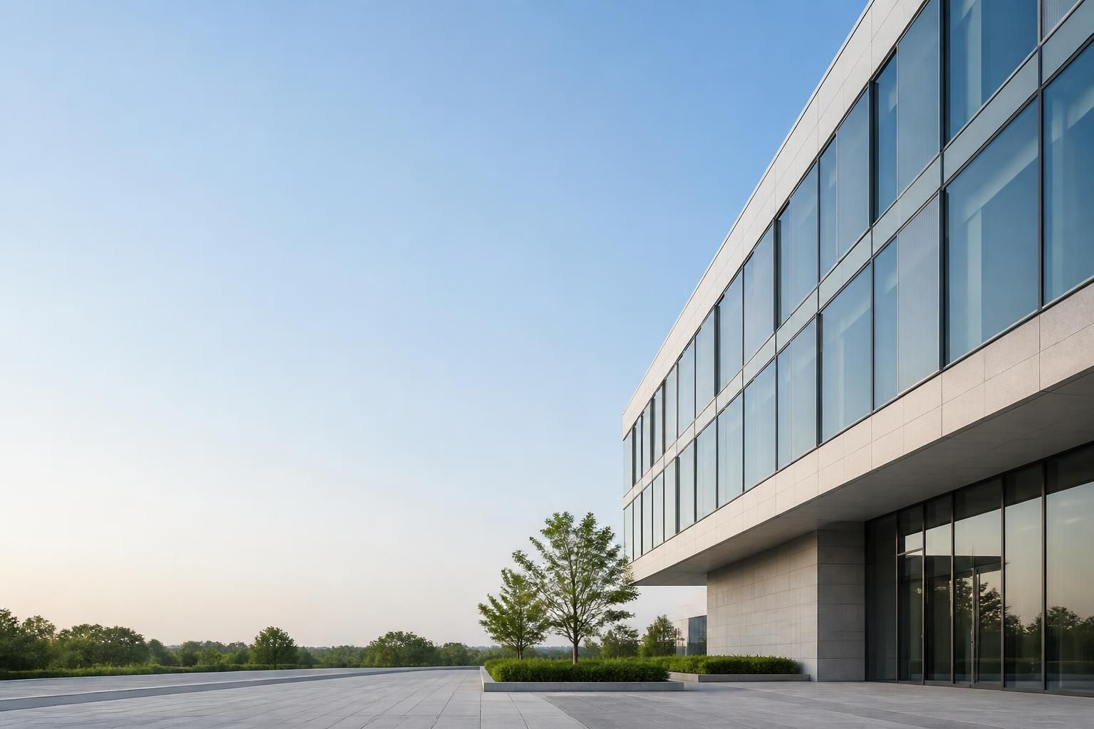 Modern building exterior with clean windows and open space.